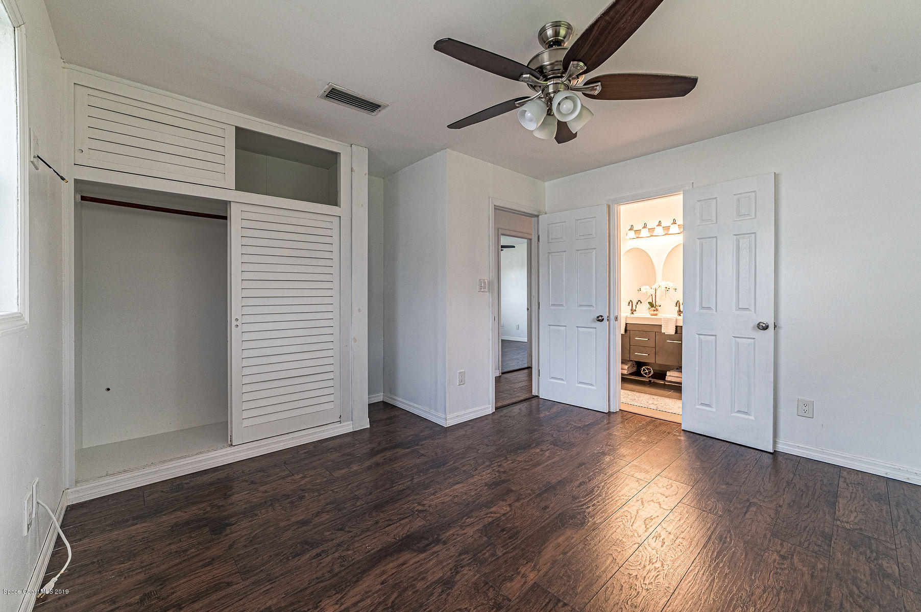 496 Seacrest Avenue Merritt Island, FL 32952 - Photo 29 of 33 wooden floor in an empty room with a window