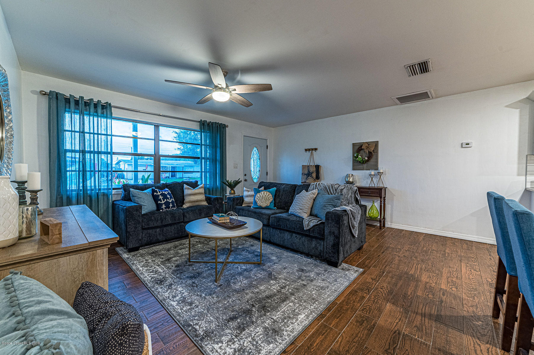 496 Seacrest Avenue Merritt Island, FL 32952 - Photo 6 of 33 a living room with furniture and wooden floor