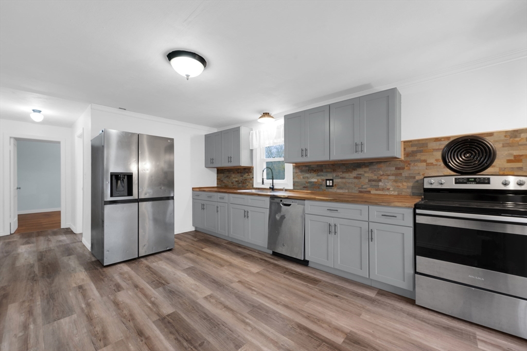 20 Leicester Street Oxford, MA 01537 - Photo 5 of 22 a kitchen with a sink a refrigerator and cabinets