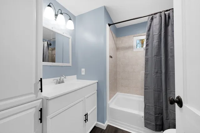 a bathroom with a bathtub a shower a sink and mirror