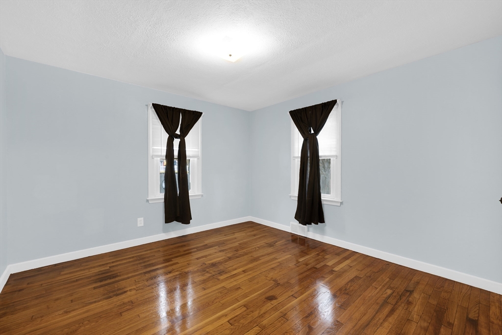 20 Leicester Street Oxford, MA 01537 - Photo 10 of 22 an empty room with wooden floor and mirror