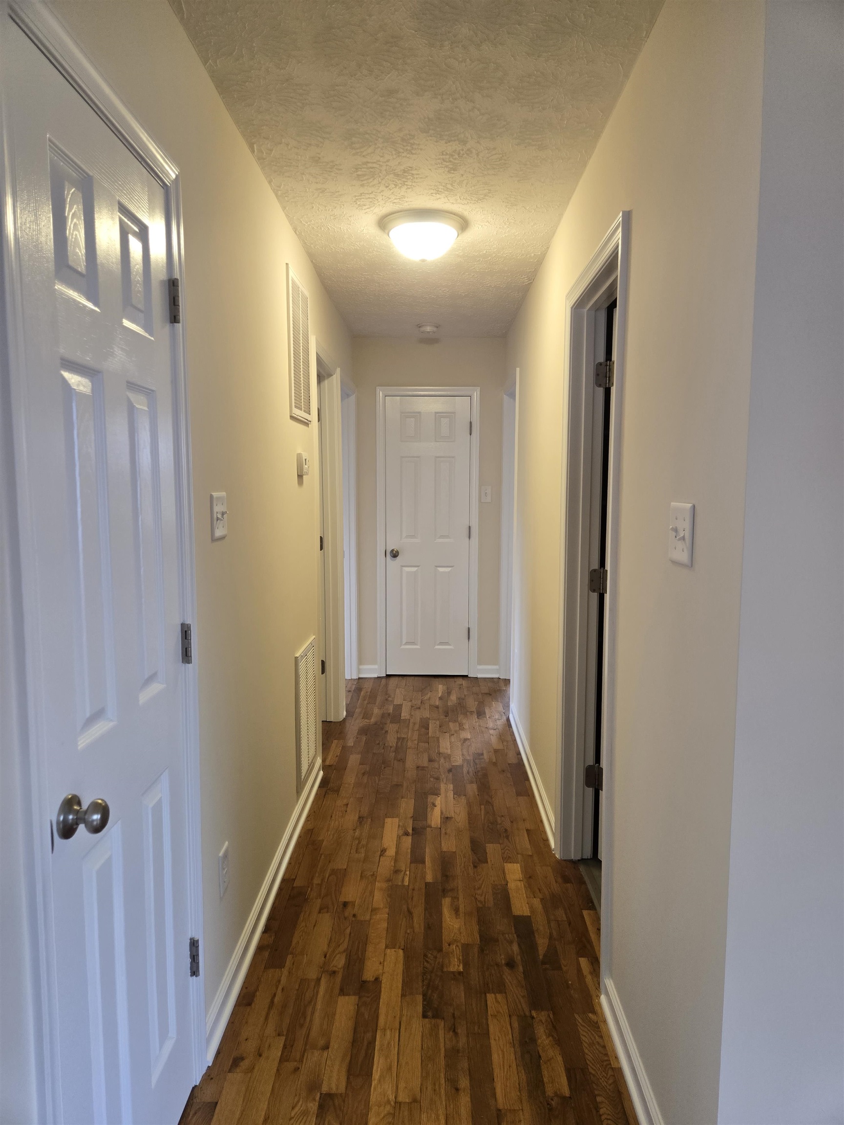 307 West Spring Avenue Elkton, VA 22827 - Photo 13 of 28 a view of a hallway with wooden floor and a bathroom