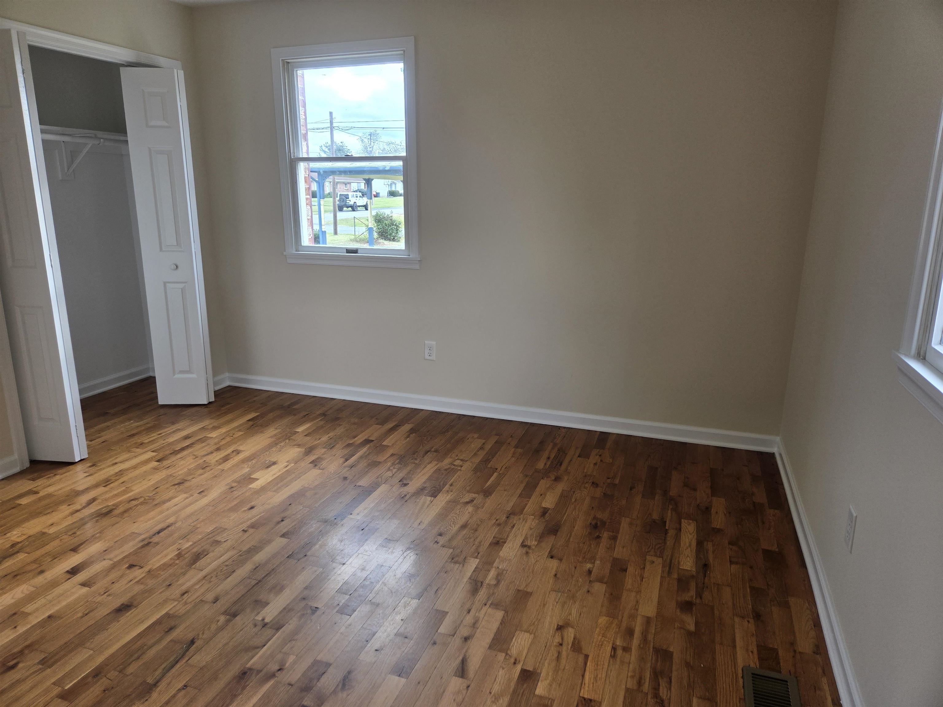307 West Spring Avenue Elkton, VA 22827 - Photo 17 of 28 an empty room with wooden floor and windows
