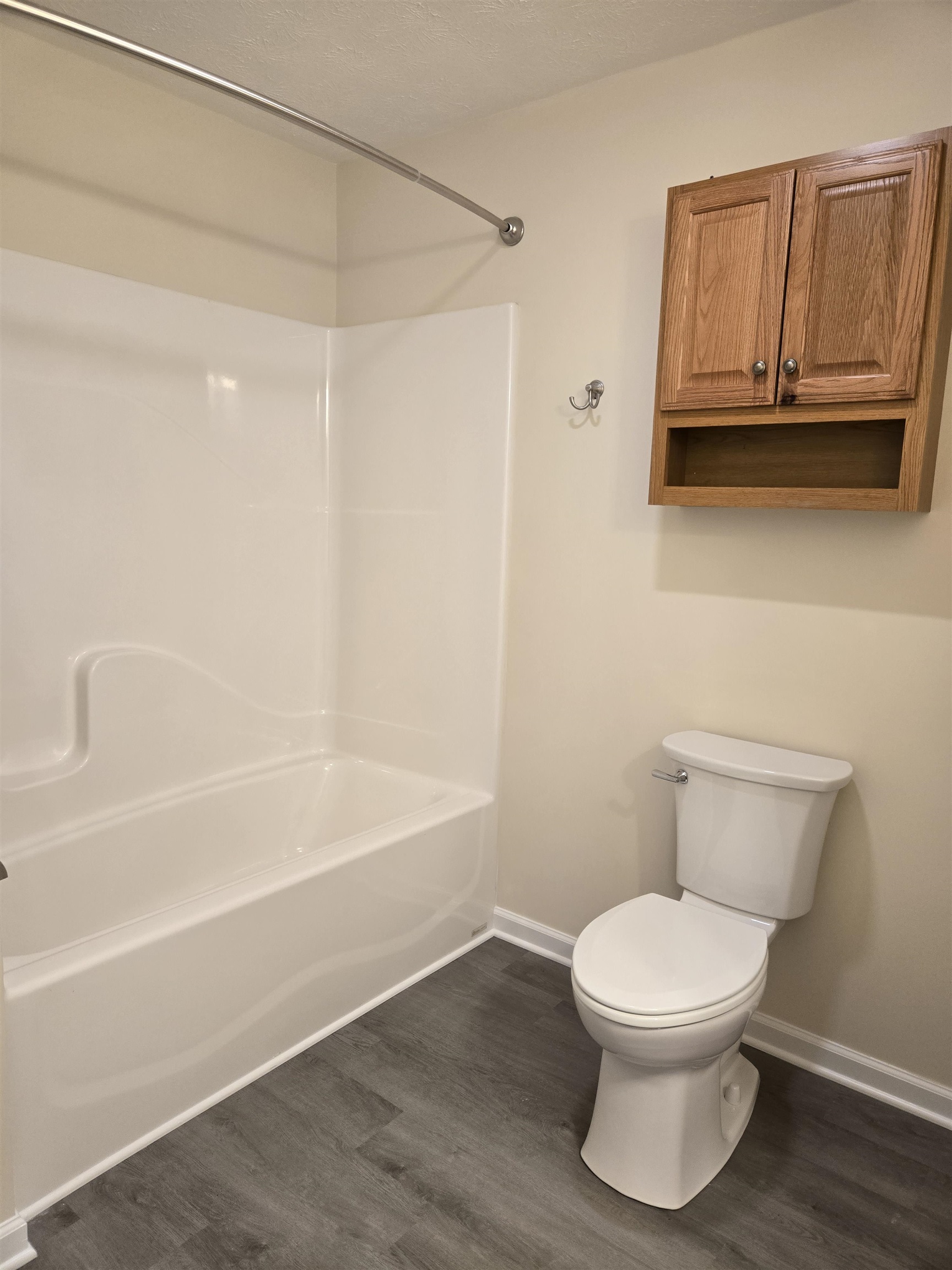 307 West Spring Avenue Elkton, VA 22827 - Photo 21 of 28 a white toilet sitting next to a bath tub