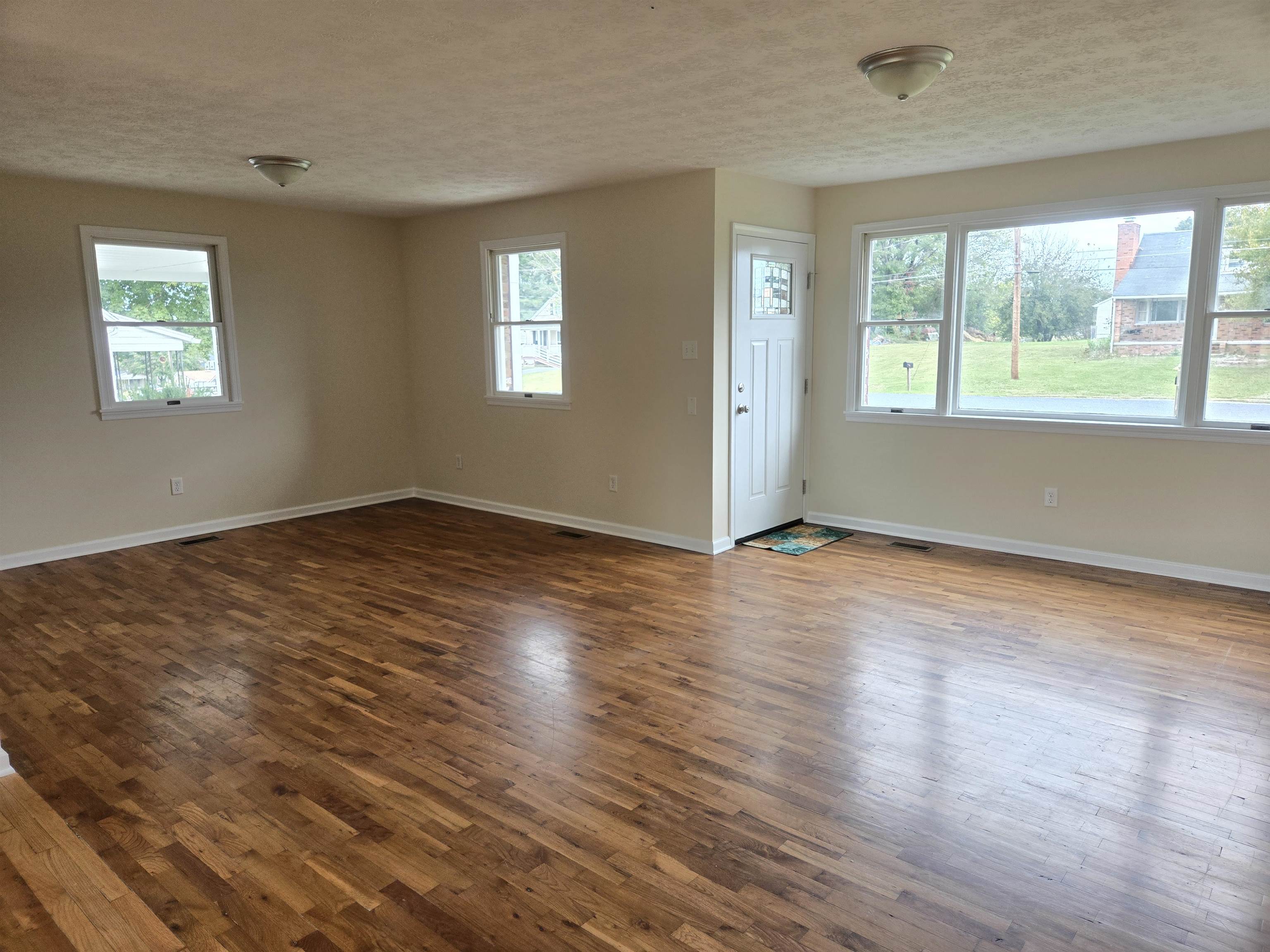 307 West Spring Avenue Elkton, VA 22827 - Photo 3 of 28 a view of an empty room with wooden floor and a window