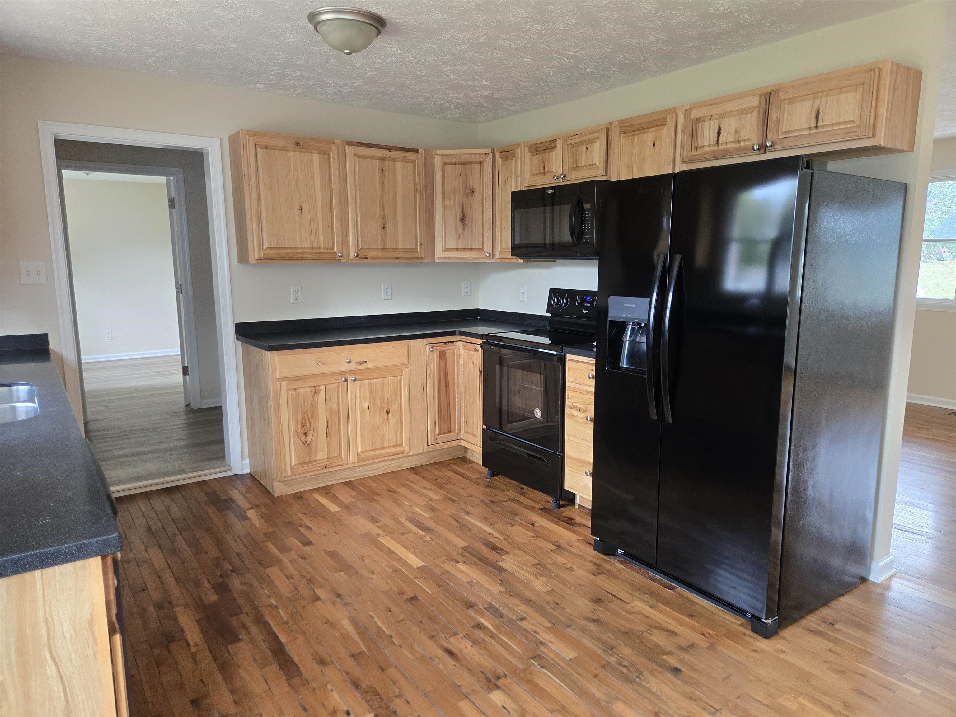 307 West Spring Avenue Elkton, VA 22827 - Photo 5 of 28 a kitchen with granite countertop a refrigerator and a sink