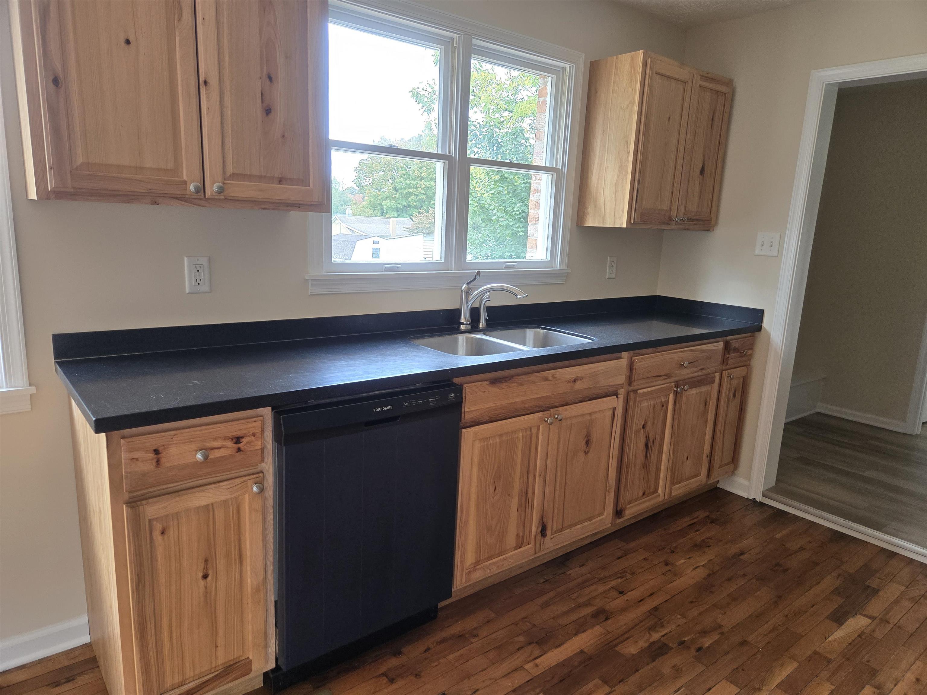 307 West Spring Avenue Elkton, VA 22827 - Photo 6 of 28 a kitchen with granite countertop wooden cabinets a sink and dishwasher