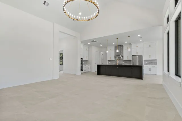 a view of a kitchen with a sink stainless steel appliances and cabinets