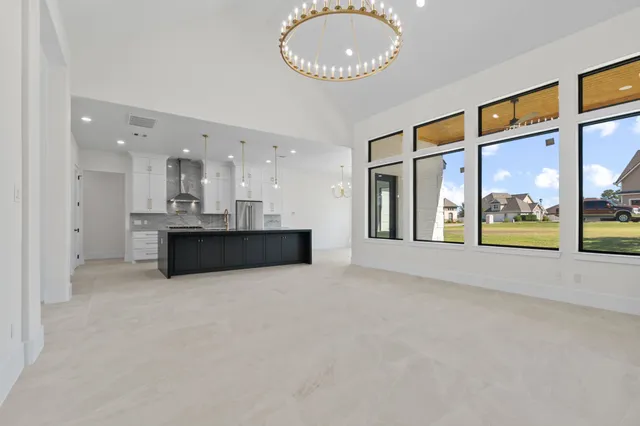 a view of a kitchen with a sink and large windows