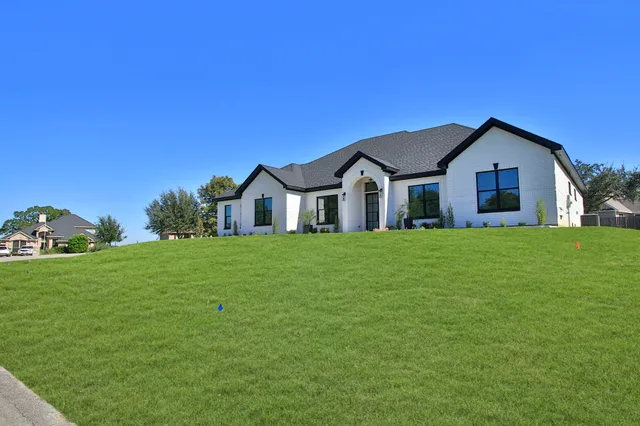 a front view of house with yard and green space