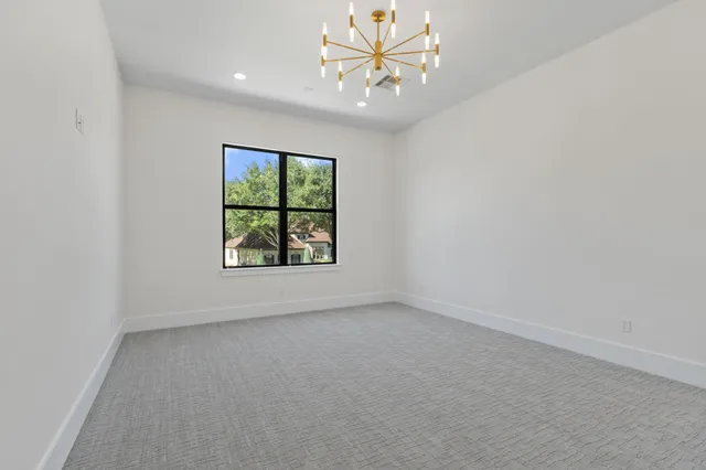 an empty room with fan and entrance