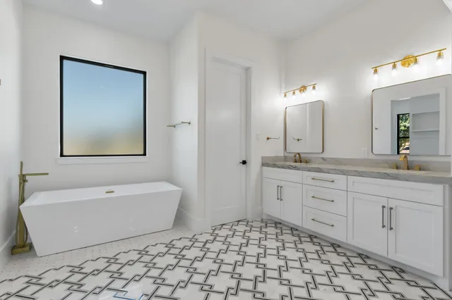 a bathroom with a granite countertop sink a mirror and a shower