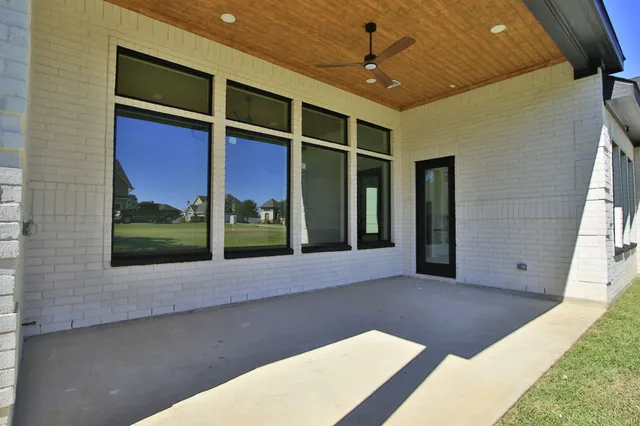 a view of an house with backyard space and tree