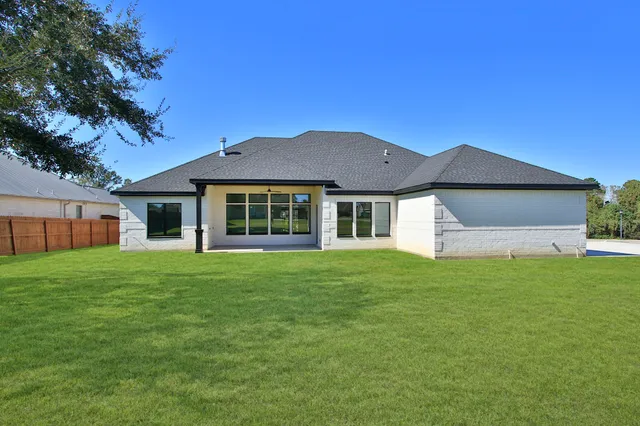 a view of yard with swimming pool and green space