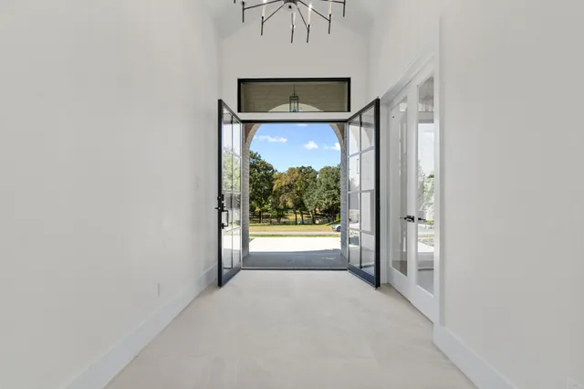 a view of a hallway with a large window and a fireplace