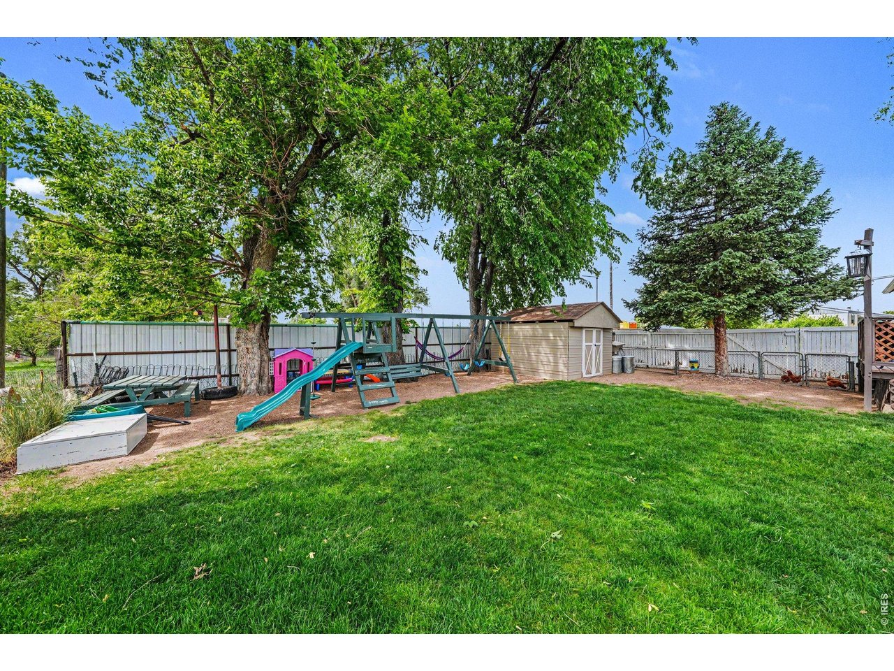 1430 30th Street Road Greeley, CO 80631 - Photo 20 of 22 a view of a backyard with sitting area and slide