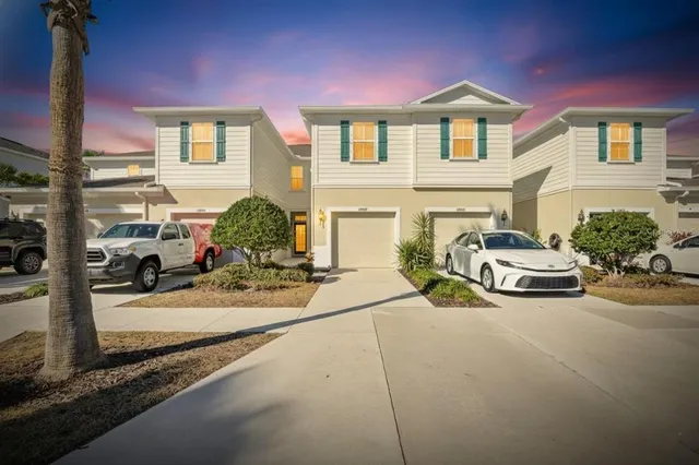 an aerial view of a house with a yard and lake view
