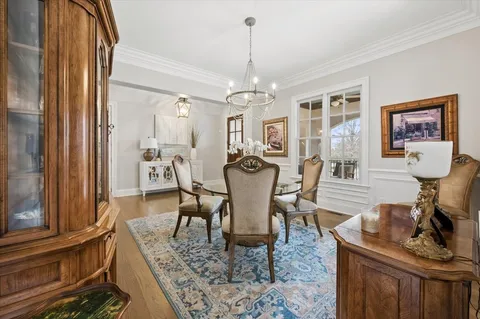a living room with furniture and hard wood flooring