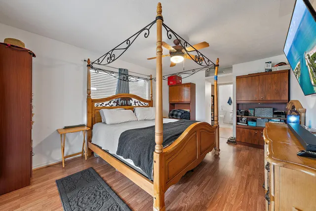 a bedroom with a bed and a mirror