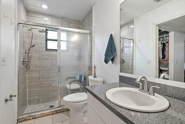 a bathroom with a sink toilet and shower