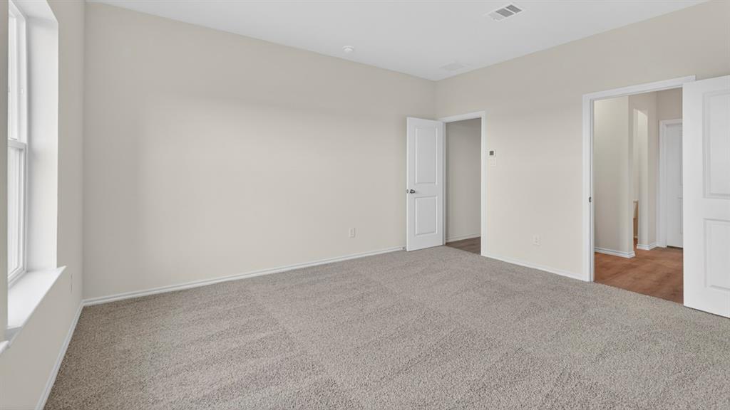 1683 Mantle Road Crandall, TX 75114 - Photo 18 of 31 Spacious room featuring neutral carpeting, light-toned walls, and a large window