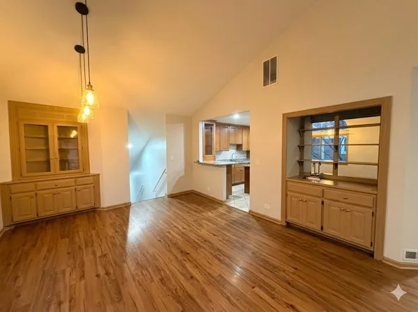 a view of a kitchen with wooden floor and a sink