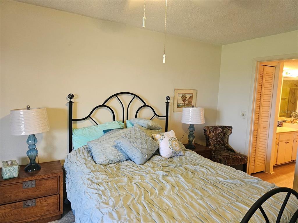 4119 61st Ave Terrace West, Unit 404 Bradenton, FL 34210 - Photo 11 of 22 a bedroom with a bed and a dresser