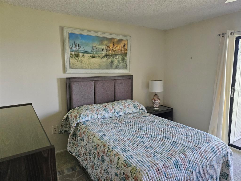 4119 61st Ave Terrace West, Unit 404 Bradenton, FL 34210 - Photo 14 of 22 a bedroom with a bed and a window