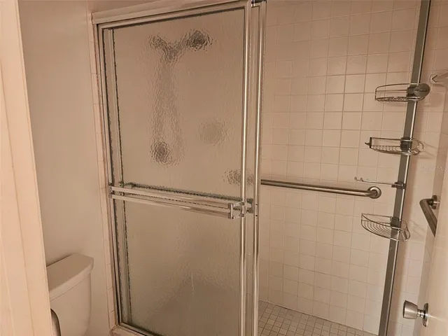 a bathroom with a glass shower door