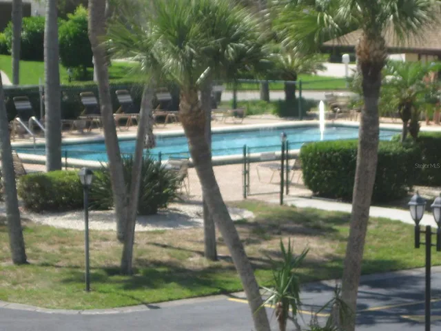 a view of a yard in front of a house with a tree