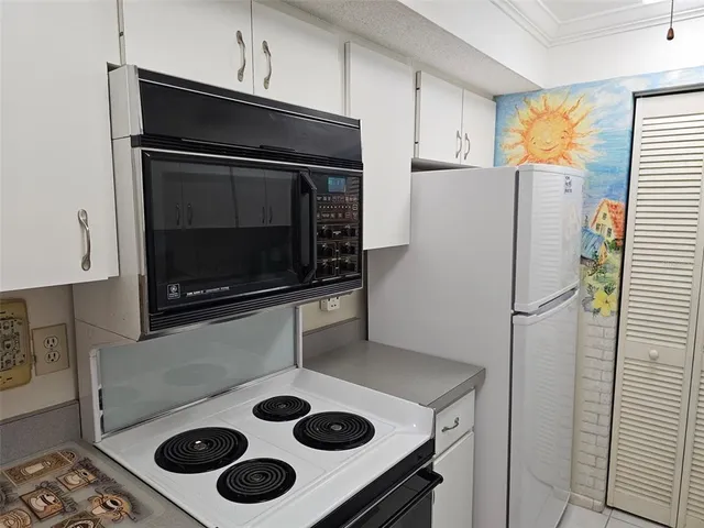 a kitchen with a refrigerator stove and microwave