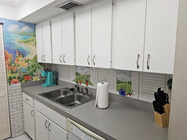 a kitchen with a sink and cabinets
