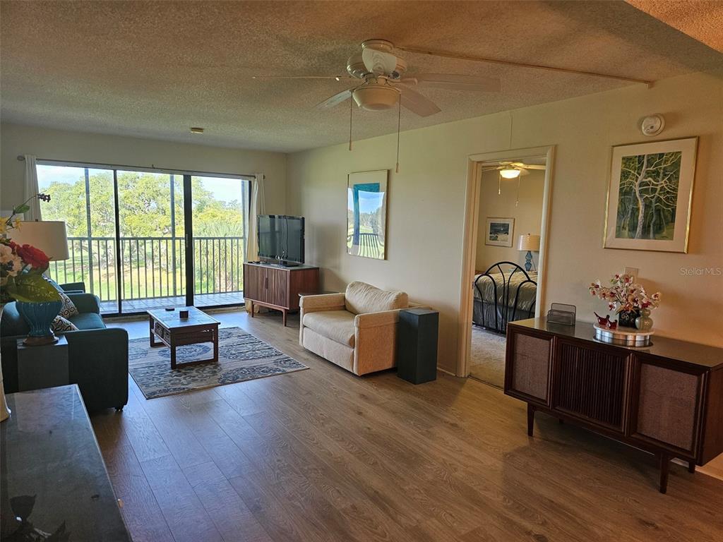 4119 61st Ave Terrace West, Unit 404 Bradenton, FL 34210 - Photo 6 of 22 a living room with furniture and a large window