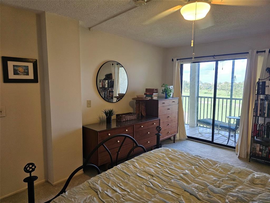 4119 61st Ave Terrace West, Unit 404 Bradenton, FL 34210 - Photo 10 of 22 a bedroom with a bed and a chandelier