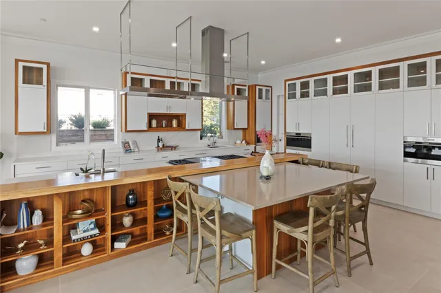 a kitchen with stainless steel appliances granite countertop a sink and a refrigerator