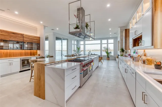 a large kitchen with stainless steel appliances lots of counter space and windows