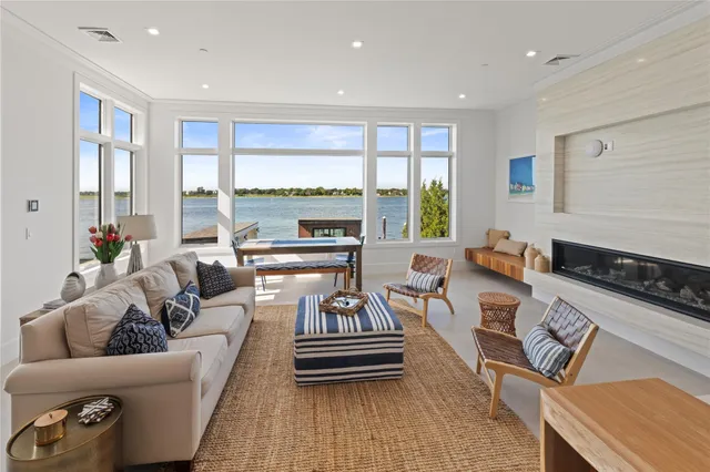 a living room with furniture and floor to ceiling windows