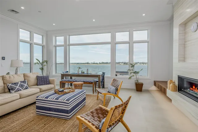 a living room with furniture and a floor to ceiling window
