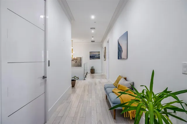 a hallway with a dining table and chairs