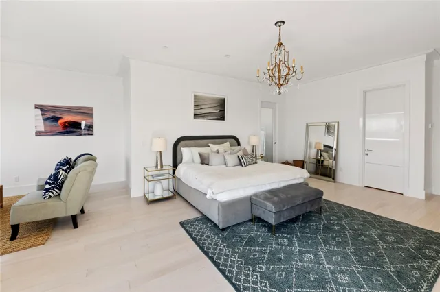 a bedroom with a bed and a chair