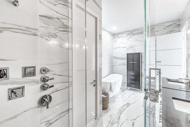 a bathroom with a bathtub shower sink and toilet