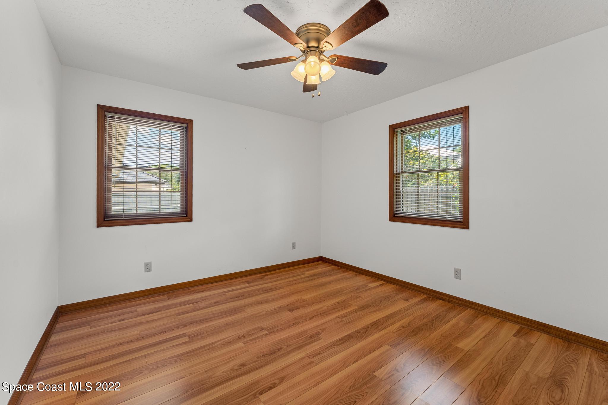 588 Peregrine Drive Indialantic, FL 32903 - Photo 11 of 23 a view of an empty room with window and wooden floor