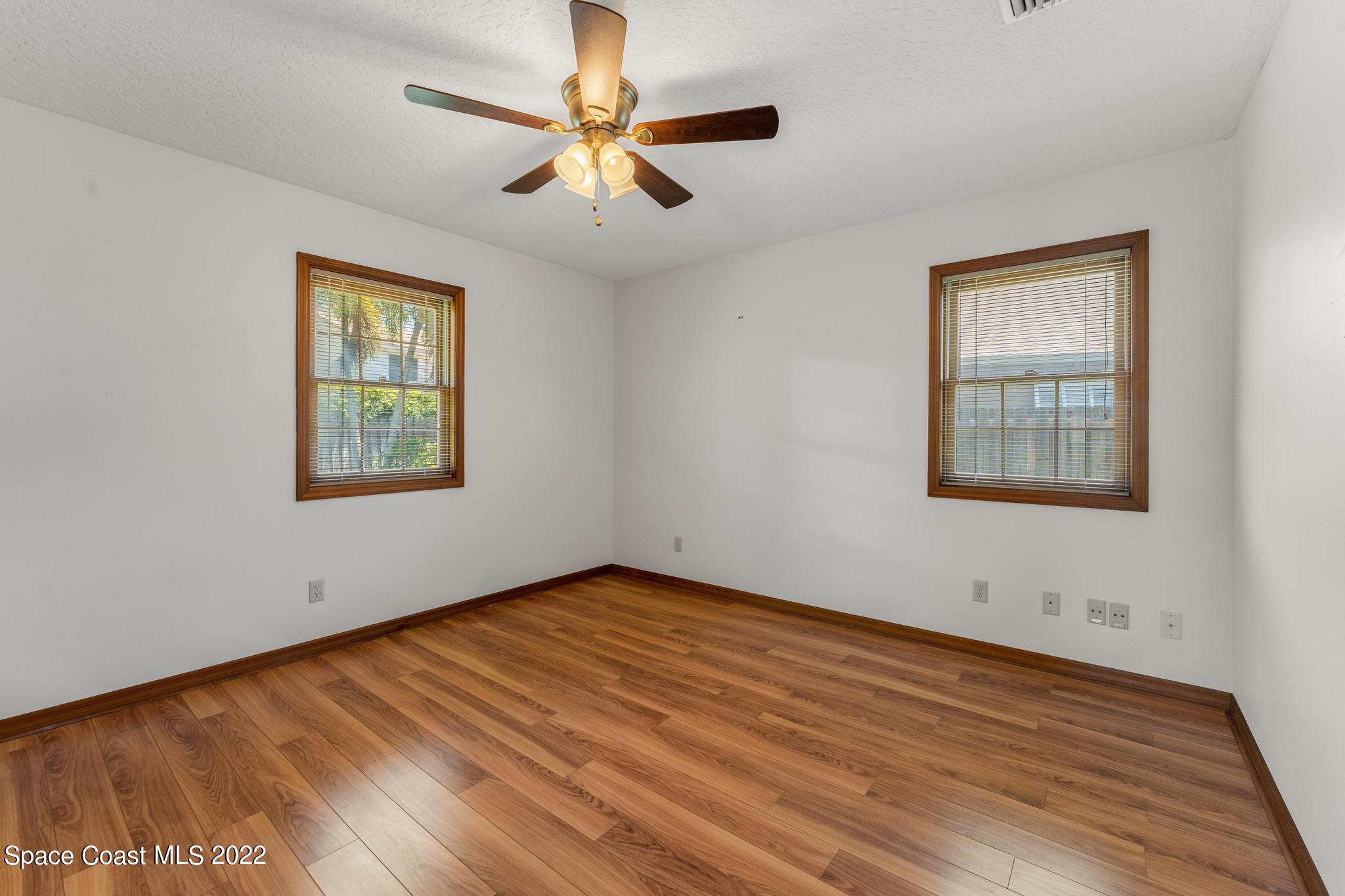 588 Peregrine Drive Indialantic, FL 32903 - Photo 13 of 23 a view of an empty room with wooden floor and a window