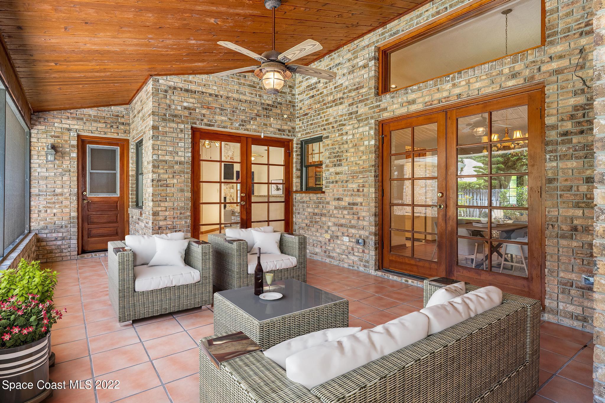 588 Peregrine Drive Indialantic, FL 32903 - Photo 15 of 23 a living room with furniture and a floor to ceiling window