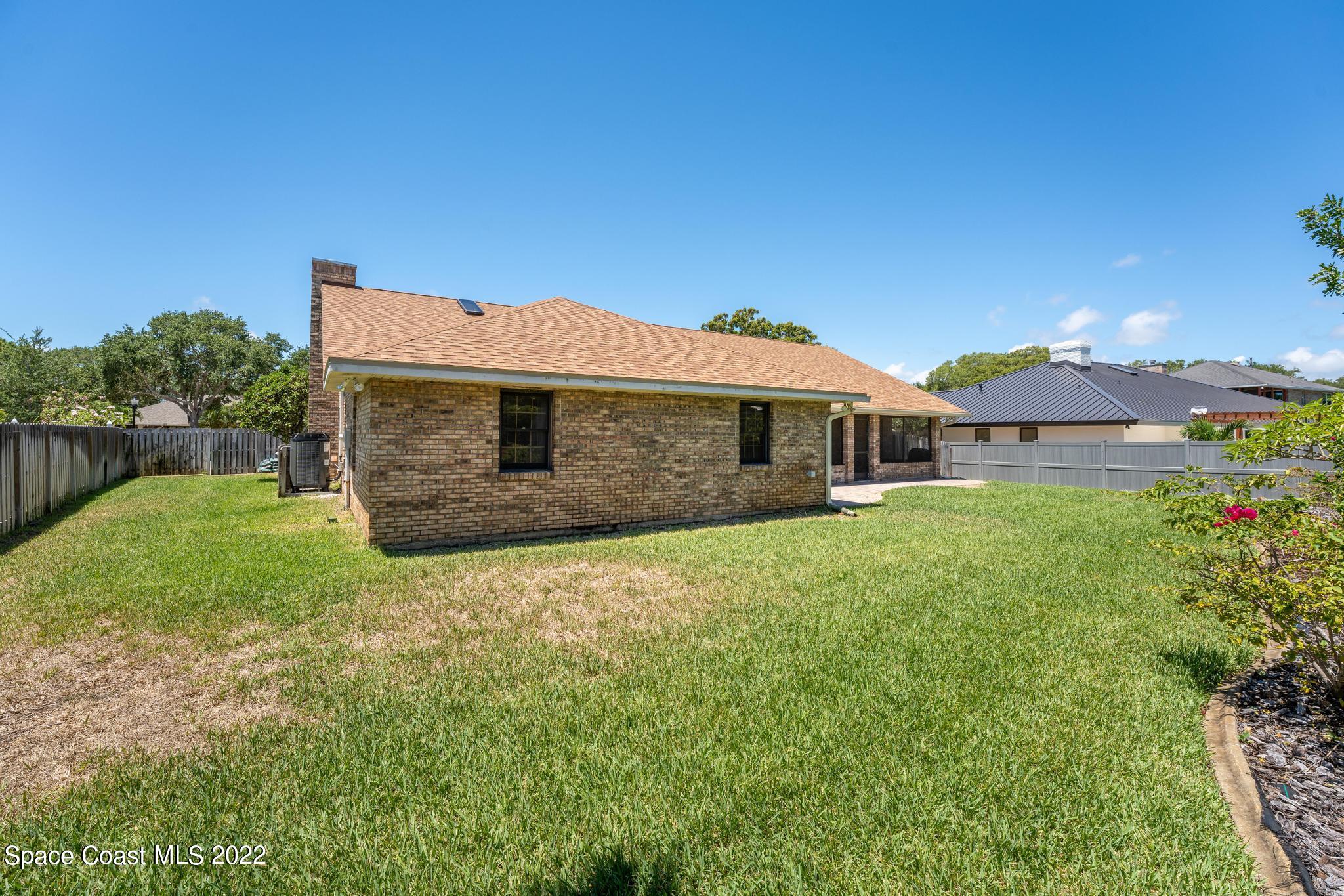 588 Peregrine Drive Indialantic, FL 32903 - Photo 17 of 23 a front view of a house with a yard