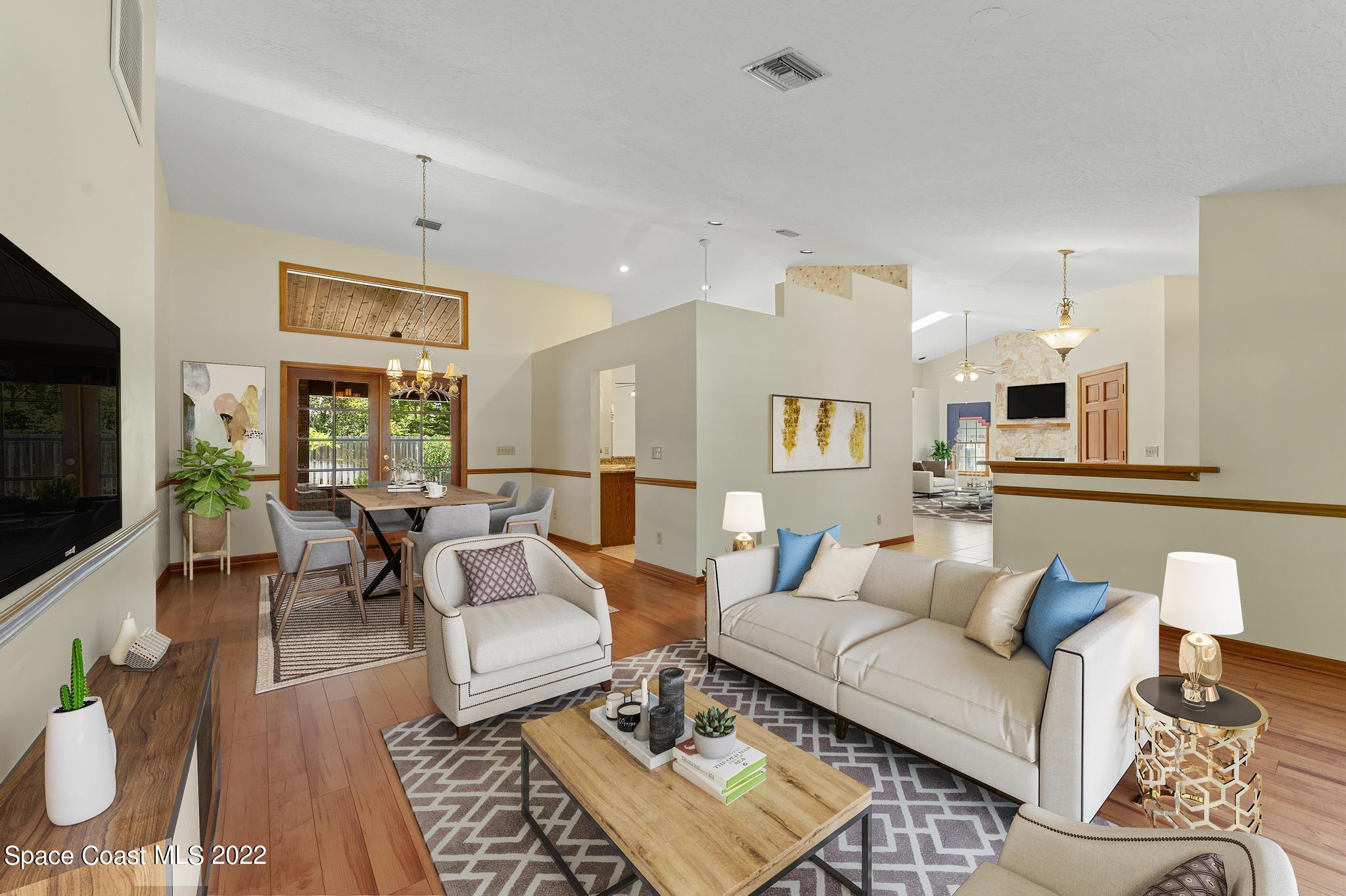 588 Peregrine Drive Indialantic, FL 32903 - Photo 2 of 23 a living room with furniture and a flat screen tv