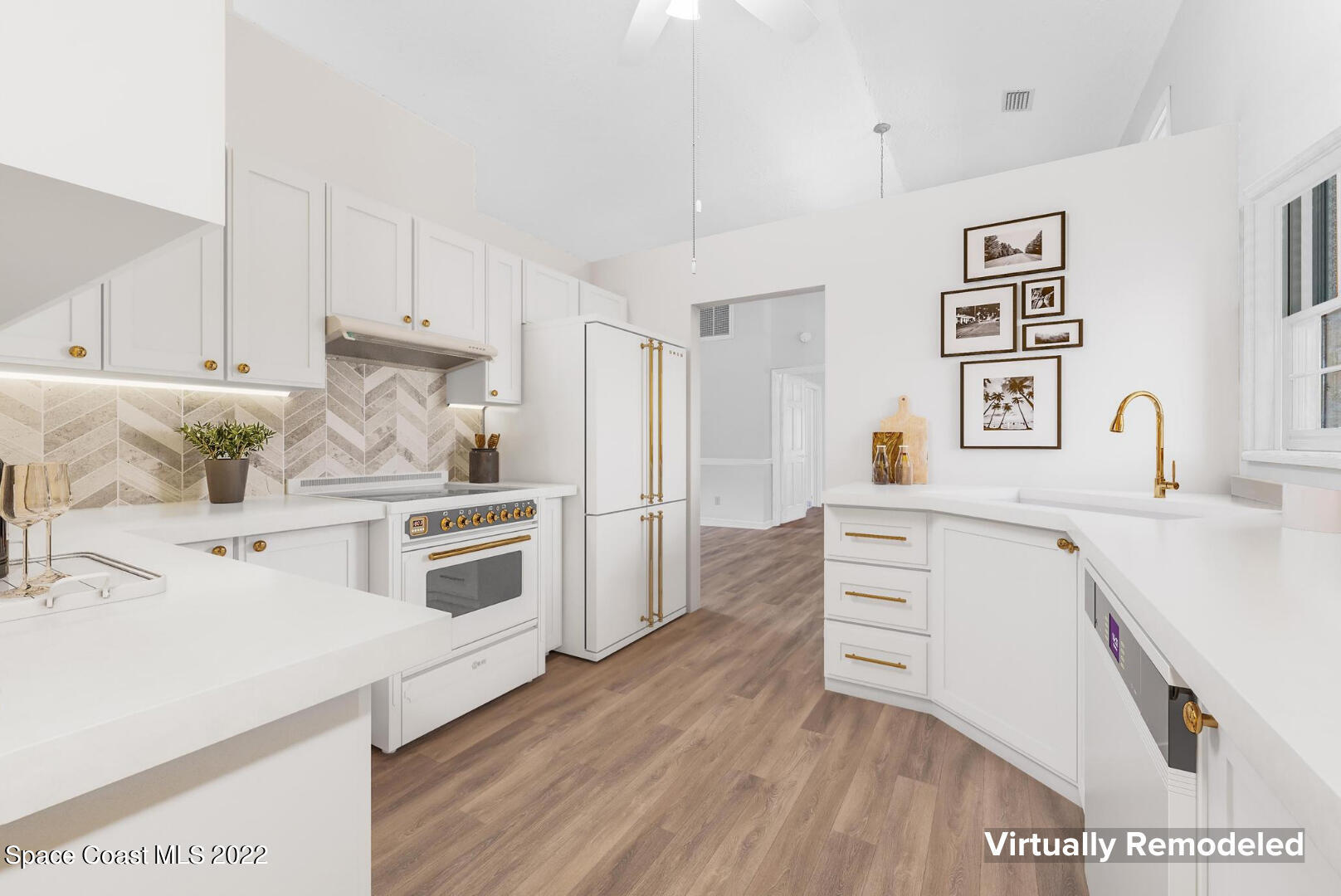 588 Peregrine Drive Indialantic, FL 32903 - Photo 4 of 23 a kitchen with stainless steel appliances a stove a sink and white cabinets