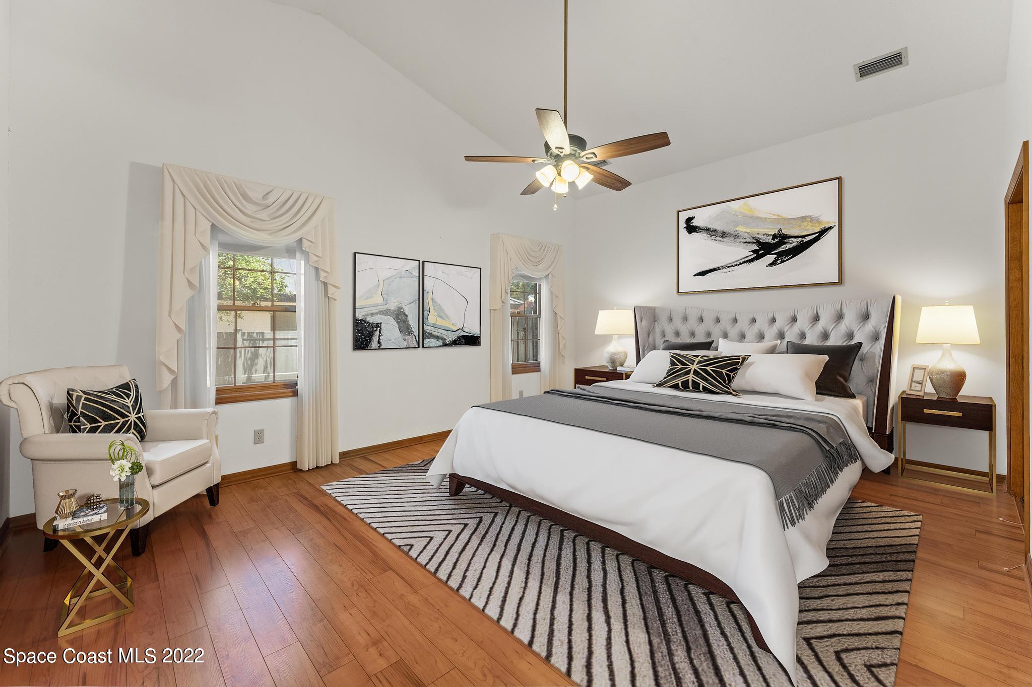 588 Peregrine Drive Indialantic, FL 32903 - Photo 8 of 23 a spacious bedroom with a bed and wooden floor