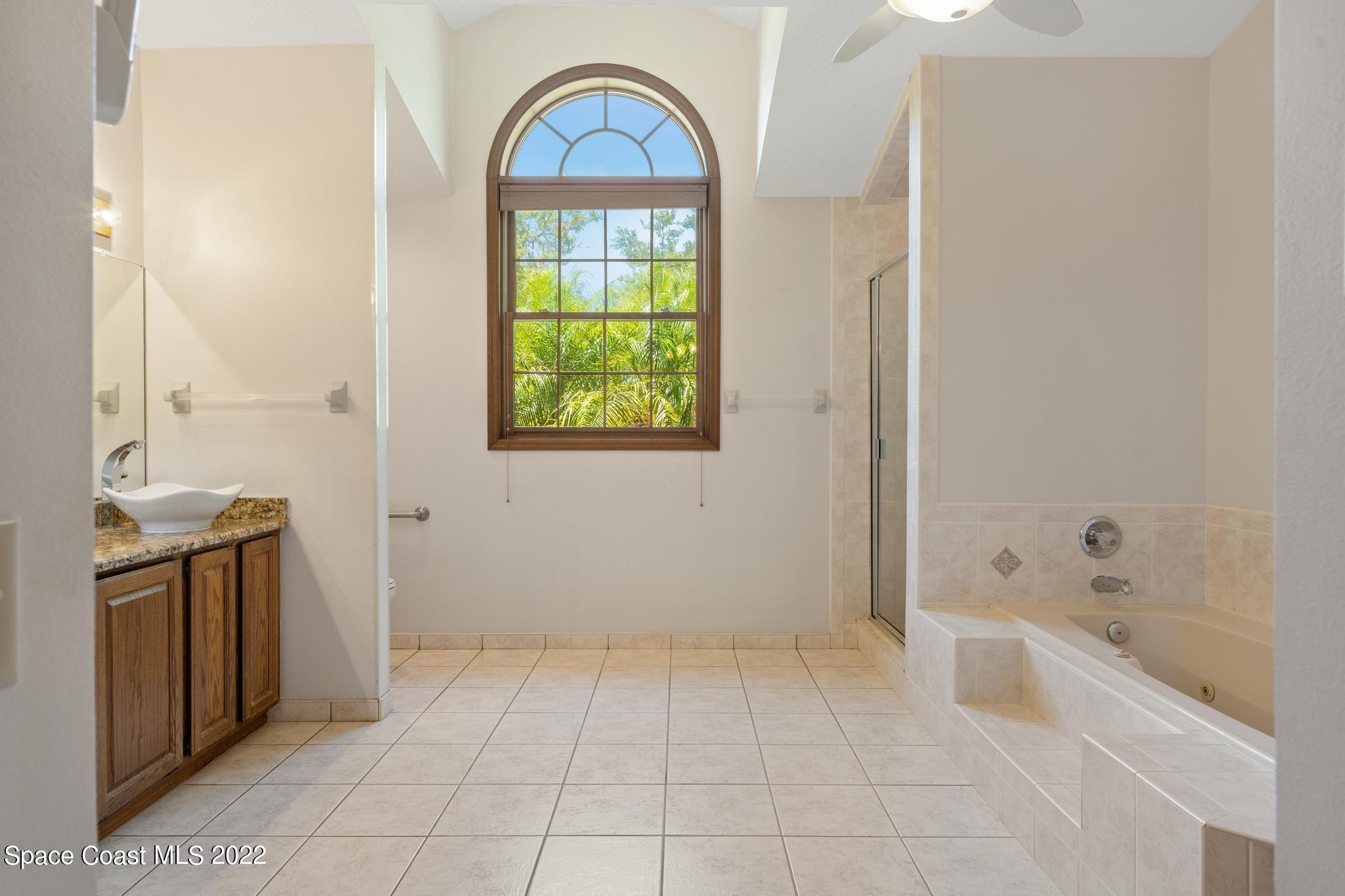 588 Peregrine Drive Indialantic, FL 32903 - Photo 9 of 23 a bathroom with a sink a toilet and a bathtub