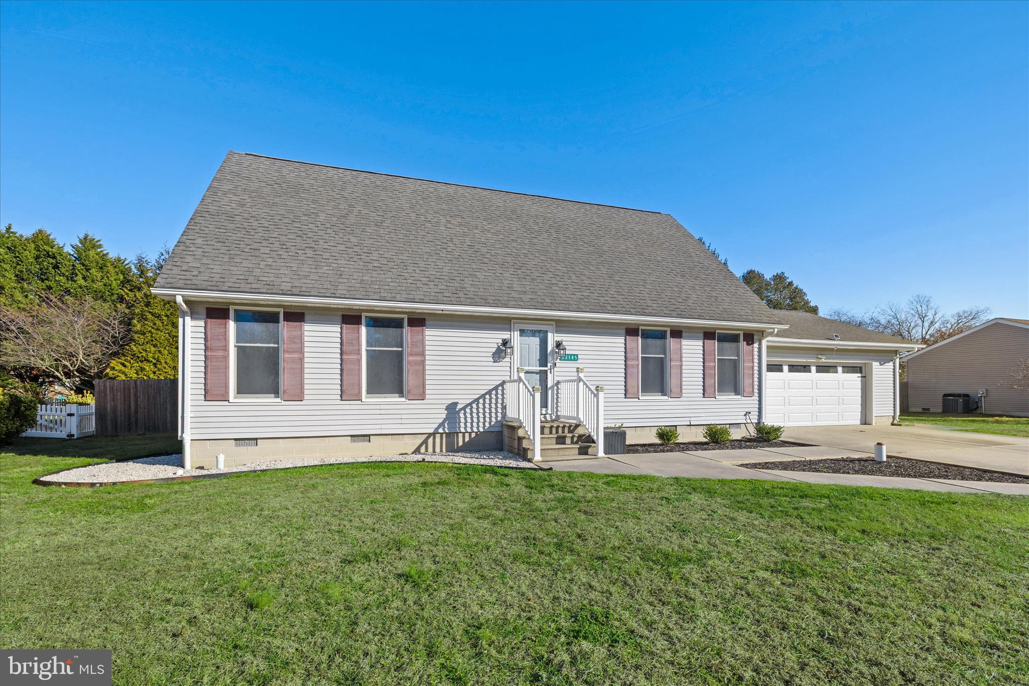 a front view of a house with a yard table and chairs